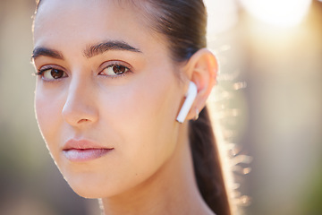 Image showing Face portrait, earphones and woman in nature streaming music, radio or podcast. Sports, fitness and female from Canada outdoors listening to audio, song or sound track and getting ready for training.