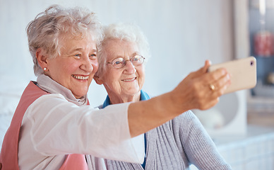 Image showing Phone, selfie and elderly friends smile for pictures to share on social media online while relaxing in retirement. Happy, love and senior women smiling while enjoy quality time at home in Berlin