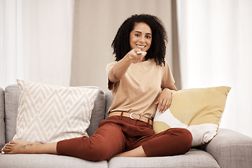 Image showing Tv, portrait and woman relax on sofa, happy and smile while channel surfing in living room at home. Black woman, remote control and watching tv on a couch, excited about weekend freedom in her house