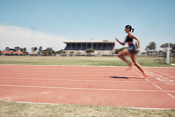 Image showing Woman, fast runner and sports on stadium track for marathon training or exercise wellness. Athlete person, motion blur and running workout or fitness cardio, energy and speed or race performance