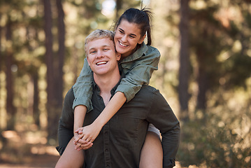 Image showing Couple, hug and smile for piggyback in nature walk, love and support for fun relationship bonding together. Portrait of happy man carrying woman smiling and enjoying quality time in the outdoors
