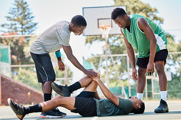 Image showing Basketball, knee injury and sport accident with team help and support in a sports competition. Fitness, workout and basketball court emergency in a exercise game with athlete on the ground in pain