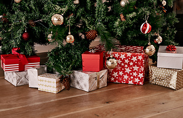 Image showing Christmas, floor and box of gift by tree for celebration, festive season and party. Xmas, surprise and gratitude with present on ground of living room with nobody for wow, announcement and holiday