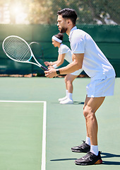 Image showing Fitness, teamwork and couple in a tennis partnership for a doubles workout game or training match in summer. Wellness, focus and healthy man playing on a tennis court outdoors with a sports partner