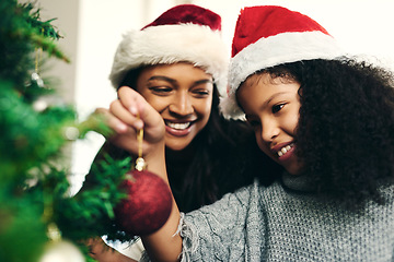 Image showing Black family, holiday and happy christmas tree decoration for celebration, bond and togetherness. Happy, mother and daughter together in home with smile excited for festive holiday in Canada.