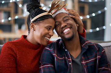 Image showing Happy black couple, sofa and christmas in home living room together, sitting and celebration. Black woman, man and smile with holiday happiness, house and relax in lounge to celebrate in festive time