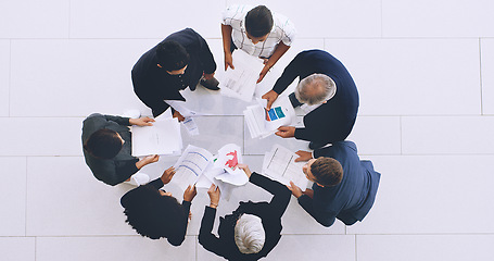 Image showing Top view, documents and business people planning a strategy in a meeting for financial increase in sales revenue. Teamwork, chart and corporate employees with paperwork for data analysis or analytics