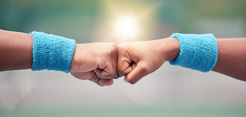 Image showing Tennis, closeup and fist bump for success, motivation and teamwork with blurred background while outdoor. Tennis player, hands and touch for respect, team building and support at training in summer