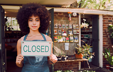 Image showing Closed sign, black woman and business failure for cafe, employee and worker with end of day. African American girl, female entrepreneur and owner holding poster for bankrupt store, company closure.