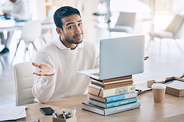 Image showing Confused, laptop and multitask with a business man shrugging his shoulders while working in the office. Desk, question and doubt with a male employee multitasking while at work on a stack of books