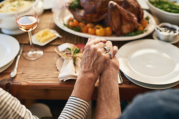 Image showing Hands, pray and food with a senior couple sitting at a dining room table for a roast lunch together. Prayer, grace and holding hands with a mature man and woman eating, bonding or enjoying a meal