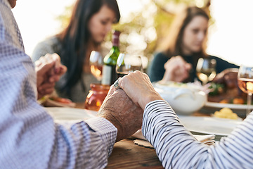 Image showing Family, prayer and lunch for thanksgiving, celebration or party in garden, backyard or outdoor restaurant. Holding hands, mindfulness and gratitude for worship, god and praying with food on table