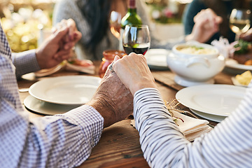 Image showing Dinner, holding hands and family prayer at table for thanksgiving celebration with faith, religion and holiday gratitude. Love, social and hand holding of people praying for party, food and wine