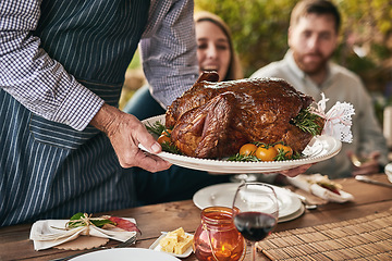 Image showing Thanksgiving, table and roast meat at party for dinner, lunch or supper at an outdoor event. Christmas, gathering and chef serving people a luxury meal or feast for festive xmas holiday dining party.