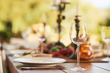 Image showing Restaurant, wine glass and table for dinner, party or thanksgiving celebration with luxury, winery and hospitality industry, Patio, plate and outdoor eating experience for lunch or drink background