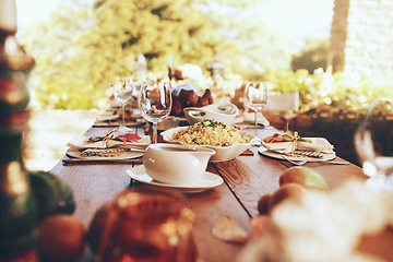 Image showing Food, celebration and dinner party in a garden for fine dining, nutrition and table setting. Lunch, celebration and tradition on a patio with a prepared dinner on a table in the backyard of a house
