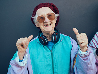 Image showing Senior woman, thumbs up and headphones for stylish fashion, glasses or modern lifestyle and happiness freedom. Yes, hands and streaming music or portrait of happy, funky elderly person with smile