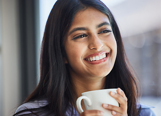 Image showing Woman, smile and mug for coffee in home for thinking, relax or vision by lounge, window or room. Girl, happy and drinking cup for beverage, tea or coco in living room, house or apartment for daydream