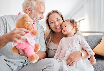 Image showing Children, family and teddy bear with a girl and grandparents playing on the sofa during a visit in their home. Kids, love and toys with a senior man and woman bonding together with their grandchild