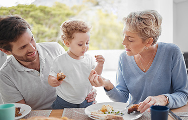 Image showing Family, food and eating with baby while feeding healthy diet or nutrition in the family lunch in home. Grandmother, child and dad with hungry boy kid and eat lunch or meal for health and wellness