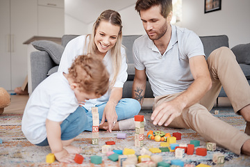 Image showing Learning, happy and family with building blocks on living room floor for child development skills. Mother, dad and young child on carpet with toys in family home for bonding, teaching and fun.