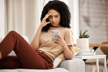 Image showing Stress, headache and phone by woman on a sofa with anxiety, bad news or break up text in her home. Confused, black woman and internet glitch on cellphone while texting, social media and browsing