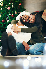 Image showing Couple, love and bonding hug in christmas house or home living room in trust, festive support and love for Brazilian celebration holiday. Smile, happy or embrace woman and xmas man on apartment floor