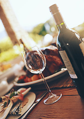 Image showing Wine, wine glass and dinner with table at party for Christmas or Thanksgiving celebration with food and drink. Alcohol, celebrate and feast with bottle, drinking and table setting for dinner party.
