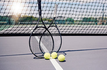 Image showing Tennis, sport and tennis ball with racket on tennis court with net background and fitness outdoor lens flare. Sports equipment, training and stadium outdoors with sunlight and physical activity.