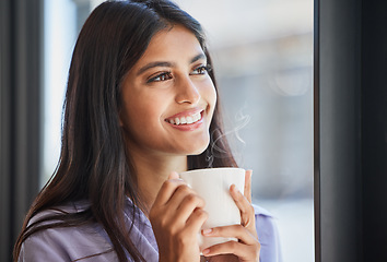 Image showing Happy, woman and coffee at a window for relax, thinking and daydream about future, goal and ideas in her home. Face, tea and indian girl smile in her living room, enjoy calm drink and window view