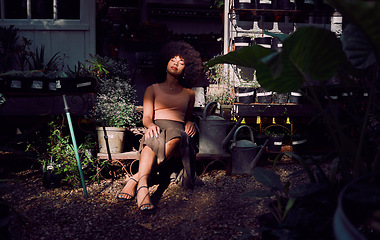 Image showing Zen, nature and black woman in a garden to relax with freedom, calm and peace in a backyard for fresh air. Green plants, environment and African girl resting or relaxing after gardening in shadows