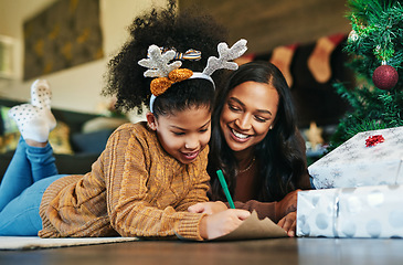 Image showing Christmas, family and writing with a mother and daughter sending a message or gift wish list to santa. Kids, love and happy with a woman and girl child lying on the living room of their home together