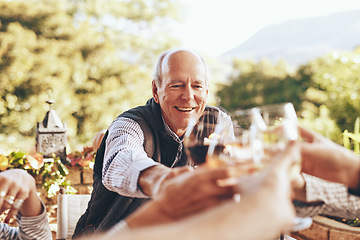 Image showing Toast, celebration and family at a lunch with wine to drink during Christmas on the patio. Happiness, solidarity and friends with a cheers and smile during a dinner party in a backyard of a home