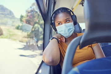 Image showing Black woman, covid and mask with headphones in transport for safe traveling, trip or destination during pandemic. African American female in public transportation with face mask for health and safety
