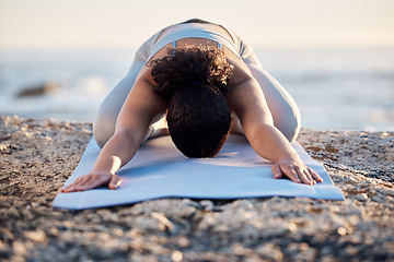 Image showing Yoga, meditate and fitness with a woman on a rock at the beach for mental health, wellness or exercise. Training, workout and meditation with a female athlete stretching outdoor in nature for health