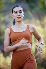 Image showing Running, woman and outdoor fitness in the forest ready for sports, runner workout and walking hike. Health wellness training, exercise and cardio of an athlete with headphones on a run or speed walk