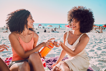 Image showing Sunscreen, beach and black woman friends with skincare for summer sunshine, outdoor wellness or holiday on sea sand. Relax, product bottle and sunblock for young women or people by ocean together