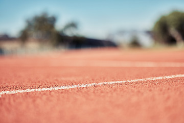 Image showing Stadium, clay running track and closeup of outdoor arena or sport pitch. Fitness, training and sports ground for running wellness, workout or healthy exercise for cardio runner development on field