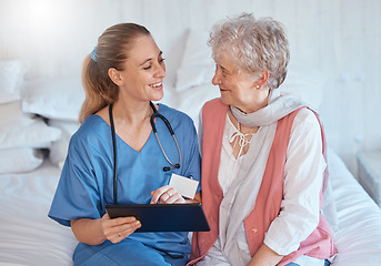 Image showing Happy, tablet and nurse consulting an old woman with medical report results or doctor healthcare diagnosis. Smile, bed and social worker helping, talking or speaking to a healthy elderly person