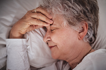 Image showing Sleep, headache and senior woman in a bed with stress, anxiety and tired. Sick, sad and face of an elderly lady dreaming with depression and sleeping in her bedroom for rest during retirement