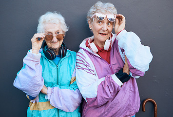 Image showing Fashion, funky and friends with a senior woman pair standing outdoor on a gray wall background together. Silly, style and edgy with a trendy mature female and friend having fun while bonding