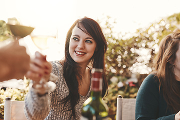 Image showing Toast, celebration and woman with glass of wine at family lunch in a garden for Christmas. Cheers, party and girl with a drink of alcohol, wine glass and happiness during an outdoor dinner in nature