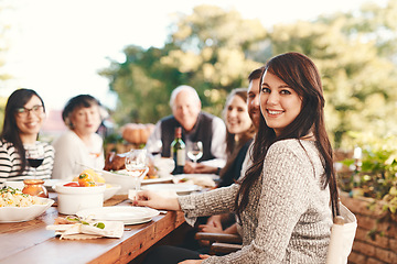 Image showing Happy woman, family and food outdoor at patio table for thanksgiving or Christmas celebration wine, alcohol and meal for dinner or lunch. Portrait of a female with friends group to celebrate holiday