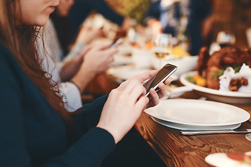 Image showing Closeup, woman and phone chatting at dinner on social media, web or app for communication at party. Girl, smartphone and internet at table, lunch or celebration in restaurant, home or thanksgiving