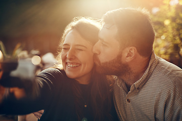 Image showing Camera selfie, couple kiss and happiness outdoor in summer smile about bonding and care. Travel of a happy boyfriend and girlfriend in nature on a walking or hiking travel feeling freedom and love