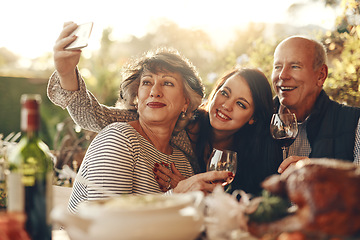 Image showing Family, phone selfie and happy thanksgiving, lunch and happy with wine, glass and social media photo in home. Senior mother, father and daughter smile, love and together for picture, alcohol and care