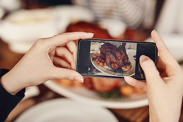Image showing Phone, photograph and thanksgiving with the hands of a woman taking a picture of food on a dinner table. Mobile, social media and Christmas with a female using her smartphone to photo a roast meal