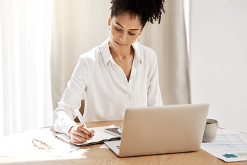 Image showing Fintech, budget and woman writing at laptop with notebook at table with finance or tax documents. Savings, strategy and planning, black woman working on payment plan for online financial investment.