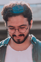 Image showing A portrait of a modern man, exuding confidence and style, against an outdoor backdrop, showcasing his charisma and fashionable demeanor.