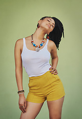 Image showing Young black woman, fashion and style with jewelry, trendy and colorful necklace with confident pose against green studio background. African model with cosmetic jewellery and stylish mock up.